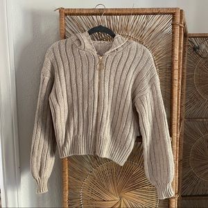 Cream colored knit sweater with zipper